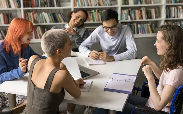 Group of students talking in a library