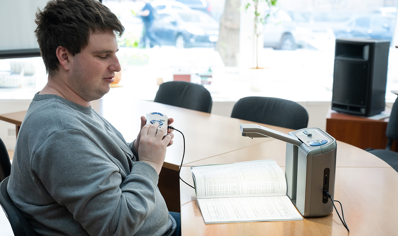 Blind student working at his desk