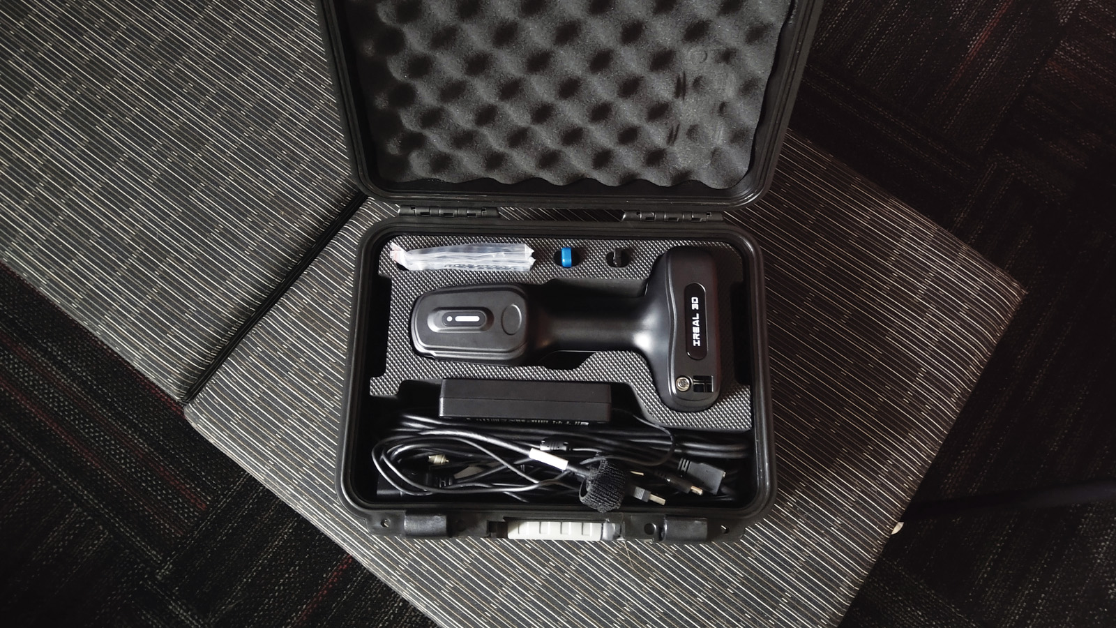 iReal 3D scanner displayed in a case