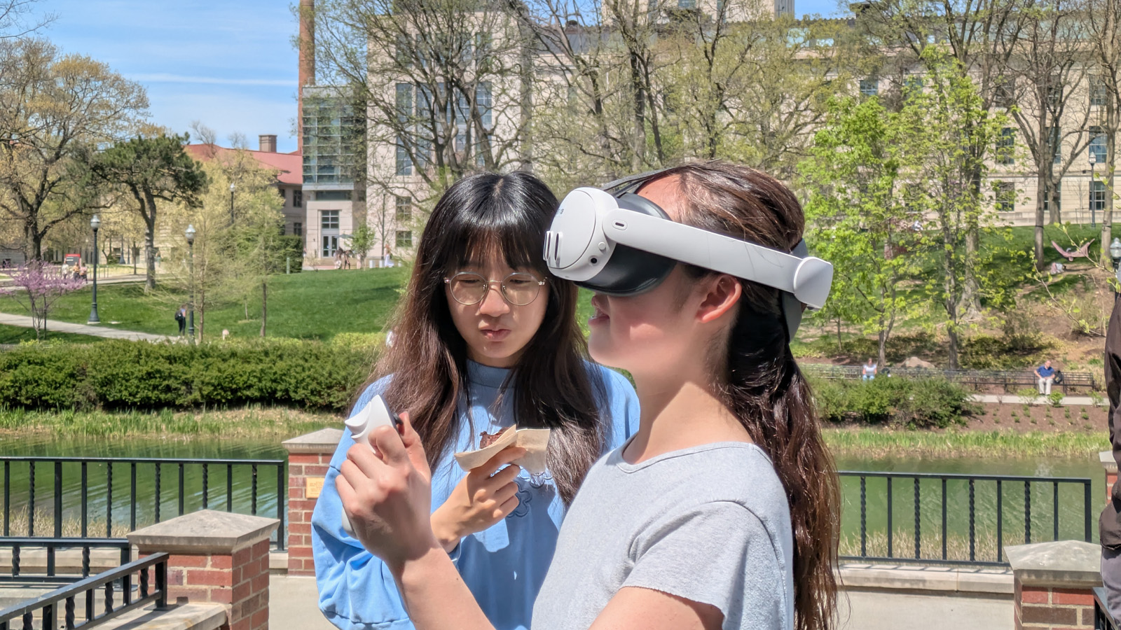 Two students interacting with the VR experience on campus