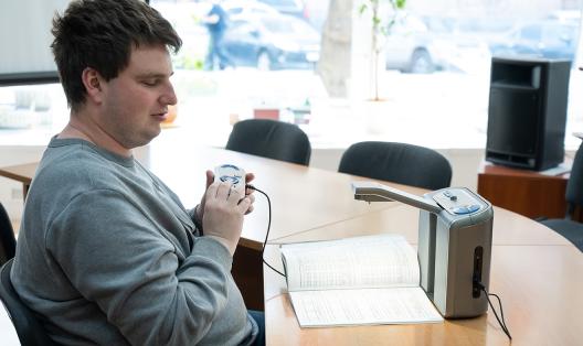 Blind student working at his desk