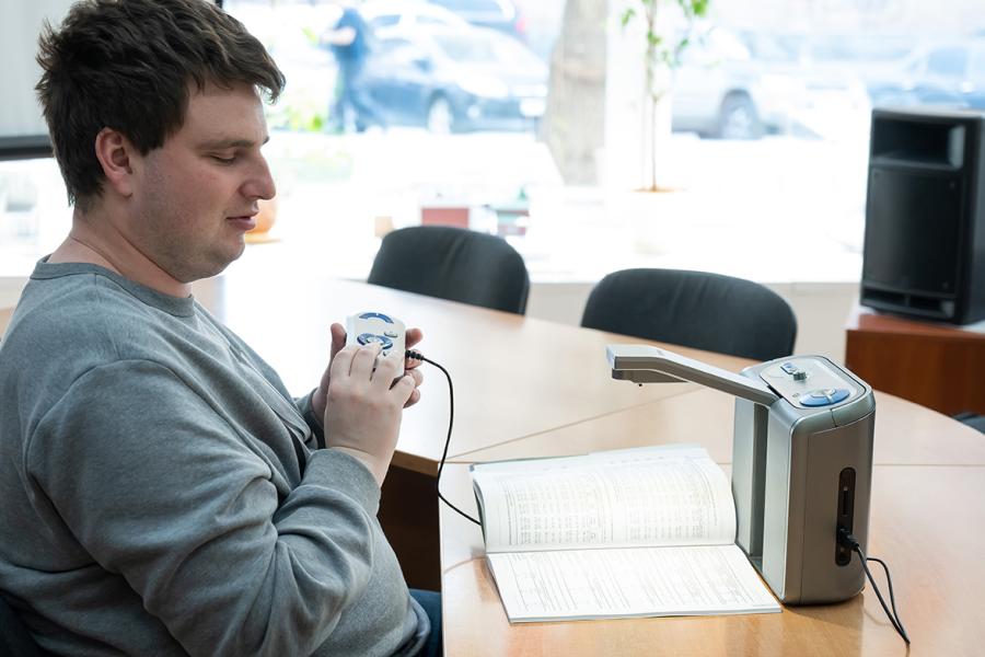 Blind student working at his desk