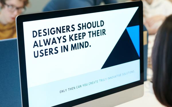 Photo of monitor reminding designers to follow universal design