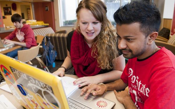 CLLC students collaborating at a laptop