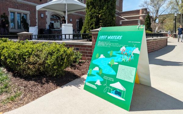 Lost Waters sign on Mirror Lake sidewalk
