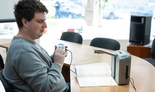 Blind student working at his desk