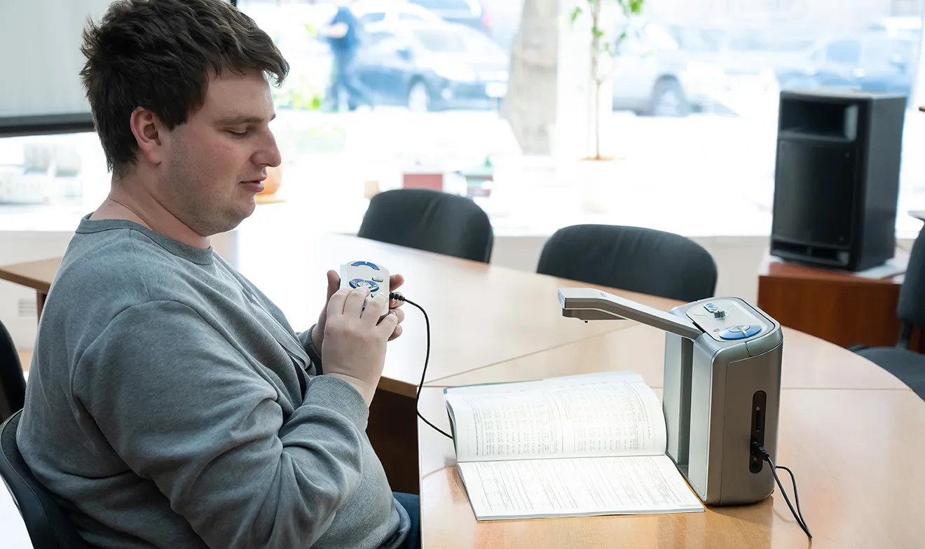 Blind student working at his desk