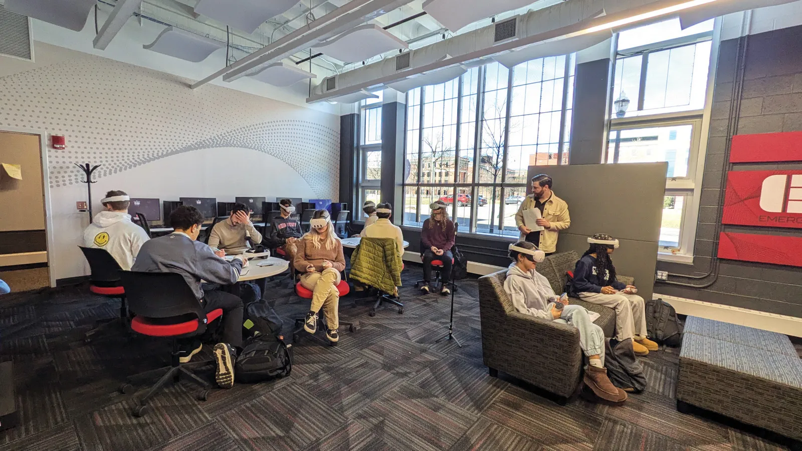 Students seated around the ETS space wearing VR headsets